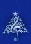 Christmas tree made of white musical notes, treble clef and pentagram on blue background with stars