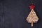Christmas tree made of  wine corks on black background. Layout, flat lay, template. New Year winter holidays background.