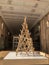 Christmas tree made of wooden planks in the interior of the commercial center. Alternative Christmas tree