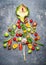 Christmas tree made â€‹â€‹of fresh vegetables on gray rustic background, top view.