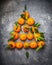 Christmas tree make with tangerines on dark rustic background, top view