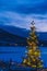 Christmas tree for the new year in the polar night on the background of the mountains in Norway on a farm in Tromso