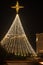 Christmas tree in the park at night, decorated with lights and star