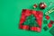 Christmas tree patchwork block, bright square pieces of fabric, pincushion, quilting and sewing accessories on green background