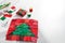 Christmas tree patchwork block, bright square pieces of fabric, pincushion, quilting and sewing accessories on white background