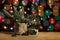 Christmas tree in pot and gift box in wrapping paper, stars and pinecone on background of color circles