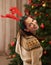 The Christmas tree is ready. Portrait of an attractive young woman decorating the Christmas tree.