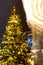 Christmas tree and a rotating carousel. Bright illumination. Fair in Moscow.