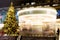 Christmas tree and a rotating carousel. Bright illumination. Fair in Moscow.