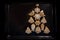 Christmas tree shape, arrangement from gingerbread cookies on a black baking tray, large copy space, flat lay, high angle view