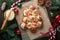 Christmas tree shape cinnamon rolls or cinnabon buns with cinnamon and cream sauce on wooden background. Festive idea for Homemade