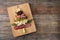 Christmas tree shaped cheese and charcuterie board with wooden background. Top view. Copy space