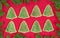 Christmas tree shaped cookies surrounded by evergreen border on