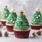 Christmas tree shaped cupcakes on light grey table, Delicious Christmas Tree Cupcakes with Decorations.