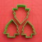 Christmas tree shaped plastic cutters on baking mat