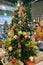 Christmas tree in shop. Christmas toys and souvenirs for decoration prepared for sale in supermarket.