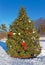 Christmas tree in snow decorated with ornaments
