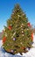 Christmas tree in snow decorated with ornaments