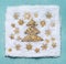 Christmas tree in snow with golden snowflakes on light blue background, top view. Flat lay. Winter