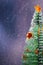 Christmas tree with stars from citrus pills on the snowfall background. Happy new year. Vertical foto. Empty space.