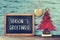 Christmas tree and text seasons greetings in a chalkboard