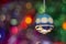 A Christmas tree toy ball on a background of multicolored tinsel