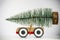 Christmas tree on toy car close up. Funny Christmas holiday celebration