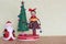 Christmas tree toy with a lady decorating with colorful balls, gifts and snowmen