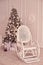 Christmas tree. White armchair. Bright interior