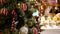 Christmas Tree with White and Red Balls in Modern Shopping Mall with Customers