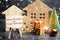 Christmas tree, wooden houses and gifts with the inscription `Merry Christmas and Happy New Year!`. New Year card. Congratulations