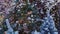 Christmas trees decorated with toys, winter garlands and illumination lights in shopping centre mall, closeup. Sales