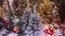 Christmas trees decorated with toys, winter garlands and illumination lights in shopping centre mall, closeup. Sales