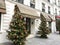 Christmas trees flank entrance to Hotel des Grands Hommes, Paris, France