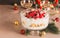 Christmas trifle and cream with berries on festive table