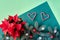 Christmas two tone background on green. Fir twigs, red poinsettia, heart shapes from candy canes.