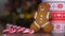 Christmas video with gingerbread man red mug with christmas ornament on light bokeh from Xmas tree and red striped holidays candie