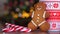 Christmas video with gingerbread man red mug with christmas ornament on light bokeh from Xmas tree and red striped holidays candie