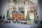 Christmas Village scene with beautiful building  and santa at gate and horses and carrages all in bay window with blurred mansion