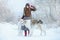 Christmas walk. Beautiful surprised woman in winter clothes with greyhound dogs graceful winter background with snow, emotions. po