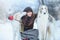 Christmas walk. Beautiful surprised woman in winter clothes with greyhound dogs graceful winter background with snow, emotions. po