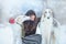 Christmas walk. Beautiful surprised woman in winter clothes with greyhound dogs graceful winter background with snow, emotions. po