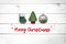 Christmas white wooden background with fir tree, green sock, and christmas ball. View with copy space. Concept holidays