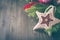 Christmas wicker star and fir tree on wooden background