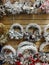 Christmas wicker wreaths of various shapes hang in rows on a shop stand for sale