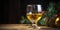 Christmas wine in glass on wooden table, cones, fir branches on dark wooden backdrop with copy space