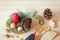 Christmas or winter composition. Top view of homemade candlestick from natural components on light wooden board.