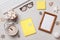 Christmas winter desktop. Ornament glasses keyboard alarm clock marshmallow frame on a gray table. Flat lay top view