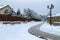 Christmas winter landscape with street lamp and brick sidewalk pavement.