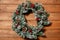 Christmas winter wreath. Christmas tree decorations. Wreath on wooden background.